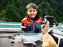 Boy with Silver salmon in Seward, AK